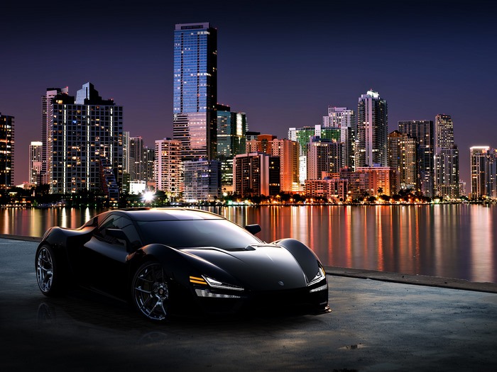 Black Trion Nemesis RR sports car in a city at night