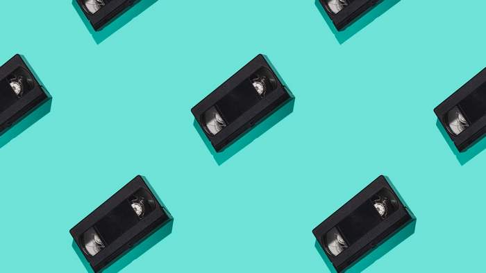 Pattern of VHS tapes on a teal background