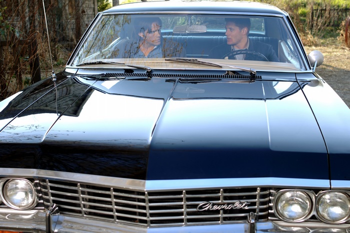 Dean and Sam Winchester from Supernatural in a Chevrolet Impala