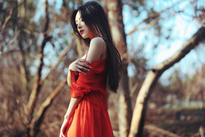 Asian Woman in Flowing Red Dress Outdoors