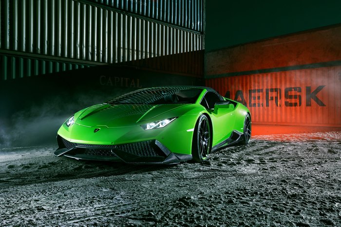Green Lamborghini Huracan Spyder parked near shipping containers