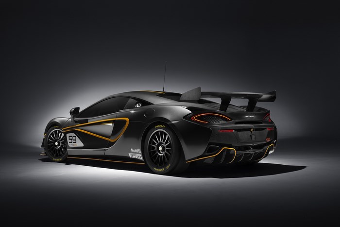 Black McLaren 570S GT4 race car with yellow accents