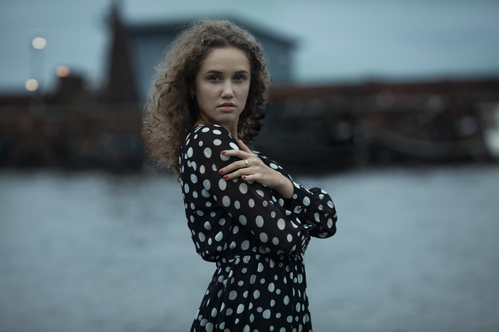 Woman with curly hair in polka dot dress