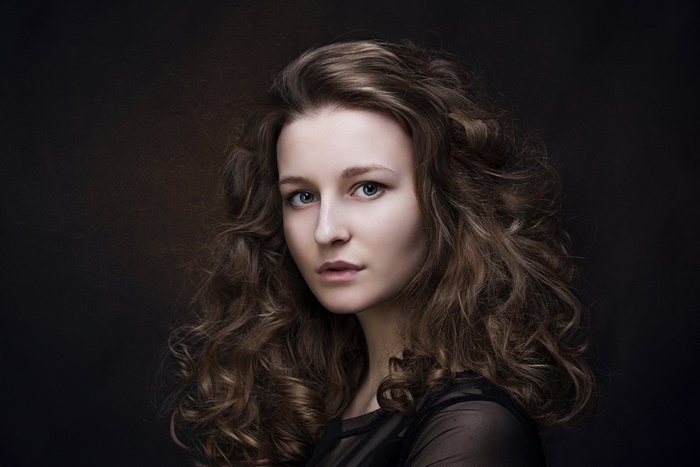 Woman with long curly brunette hair