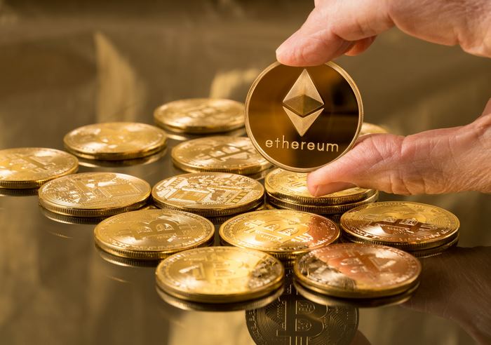 Ethereum and Bitcoin coins on a reflective surface