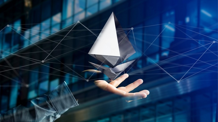 Ethereum cryptocurrency symbol held over a hand