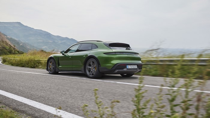 Green Porsche Taycan Turbo S 4K driving on a winding road