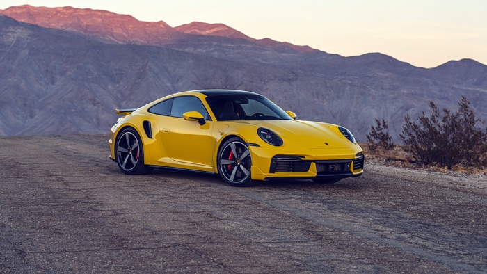 Yellow Porsche 911 Turbo S in desert landscape