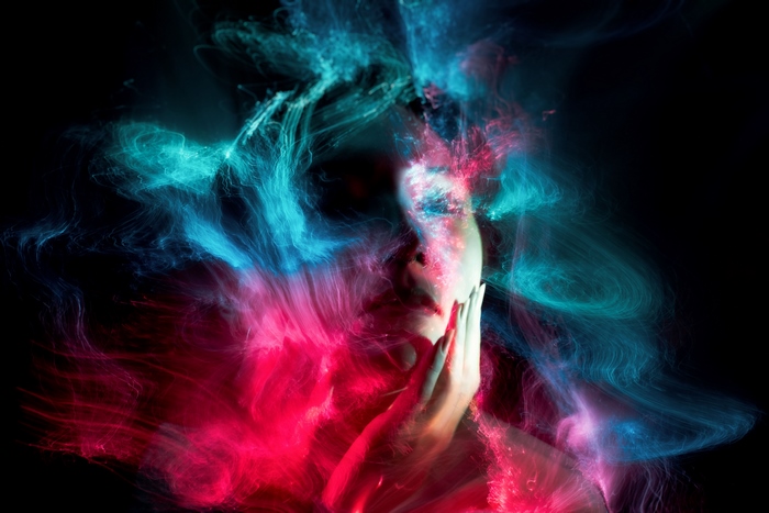 Artistic 4K portrait with red and blue light trails