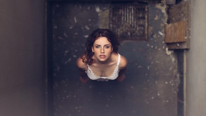 Female Model Looking Up in Urban Setting