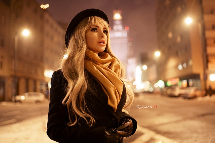 Woman in hat and scarf at night