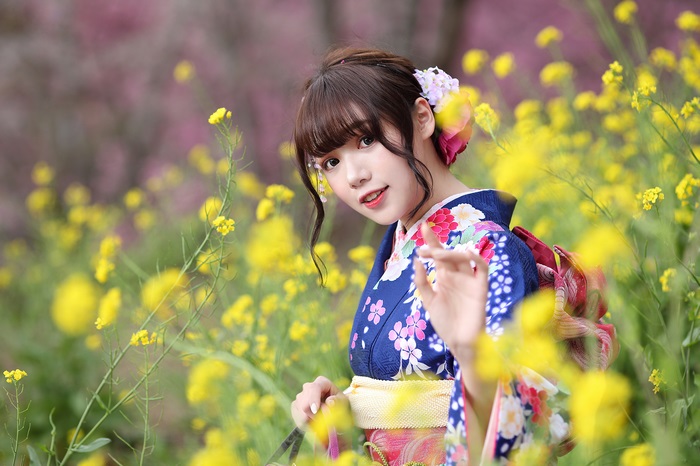 Woman in Kimono among yellow flowers