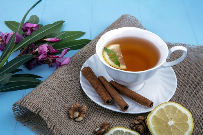 Tea with lemon, cinnamon, and flowers