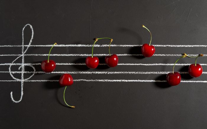 Cherries on a musical staff