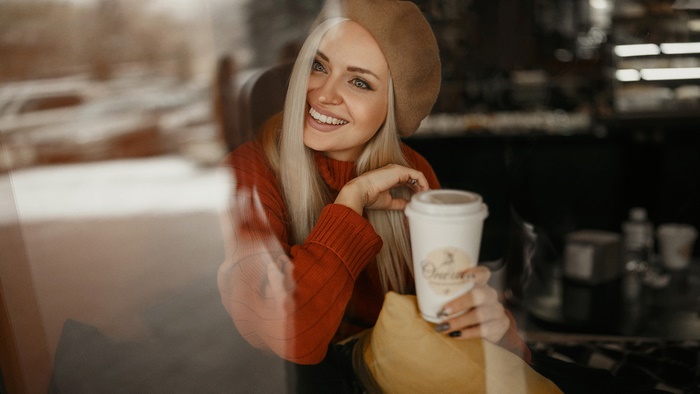 Woman in Beret and Sweater Holding Coffee Cup