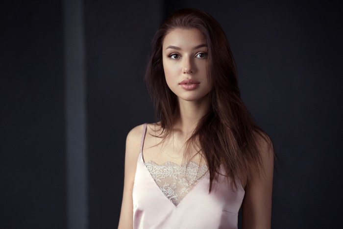 Brunette woman with brown eyes wearing a pink camisole
