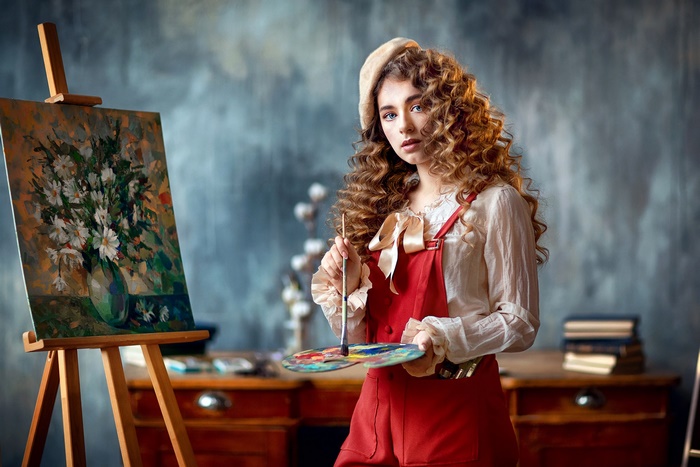 Young woman artist painting flowers