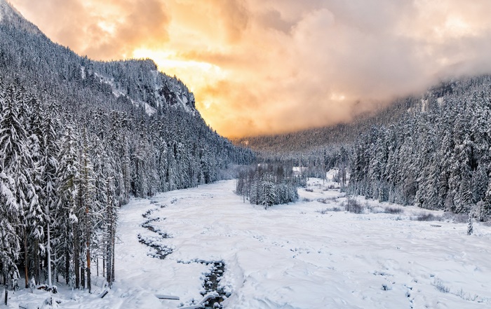 Winter Sunset Over Snowy Mountain Valley