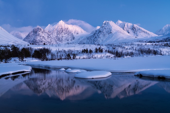 Snowy Mountains Reflecting in a Calm Lake in Norway