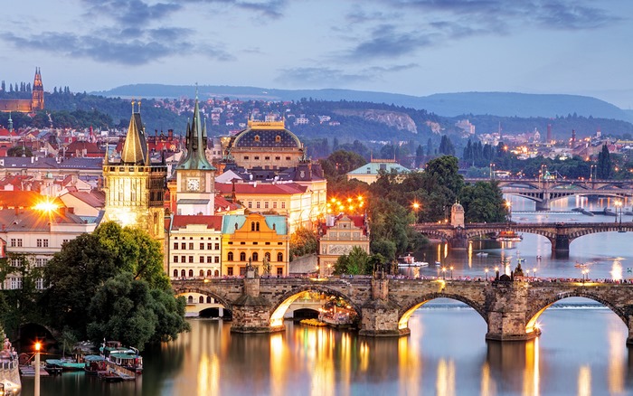 Charles Bridge and Prague skyline at dusk
