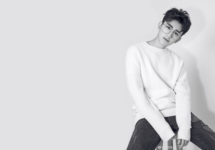 Zhu Zanjin wearing glasses and a sweater