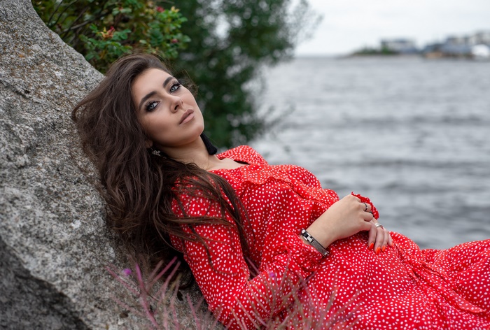 Woman with black hair and blue eyes in red dress