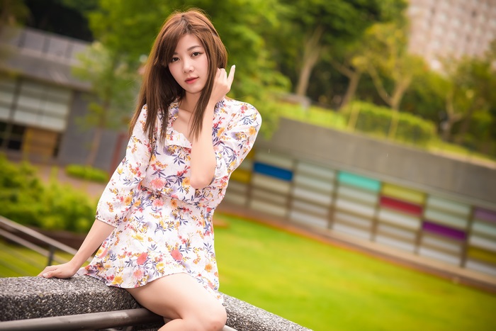 Asian woman in floral dress with depth of field