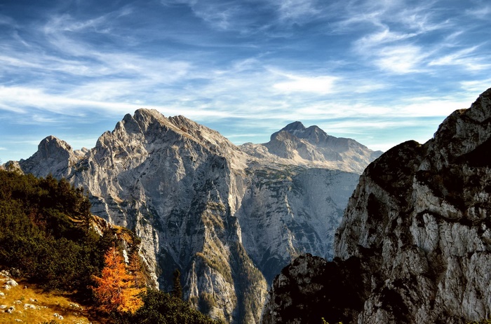 Majestic mountain range under a cloudy blue sky