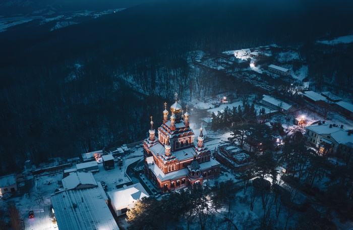 Orthodox Church in Snowy Forest at Night