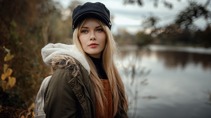 Woman with blonde hair wearing a hat and jacket