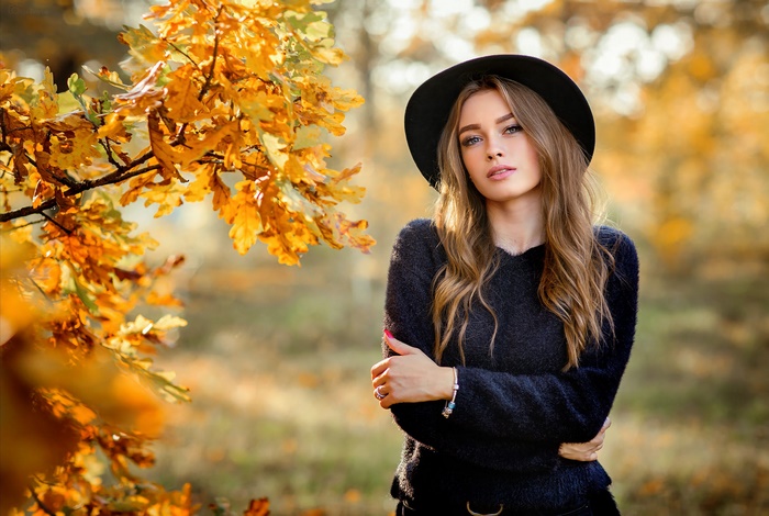 Woman in Black Hat Among Autumn Leaves