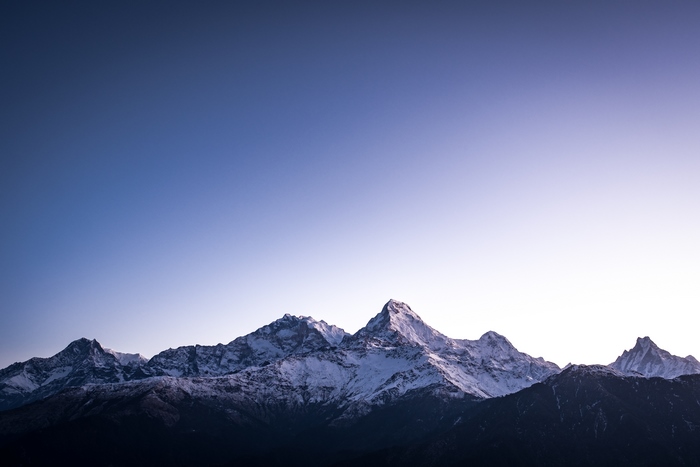 Snow-capped mountains under a gradient sky