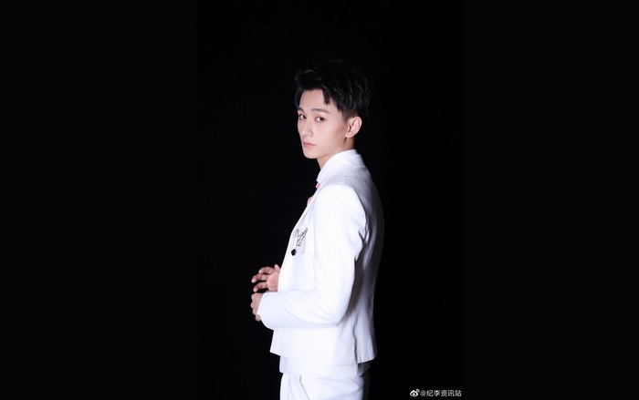 Ji Li in a white suit