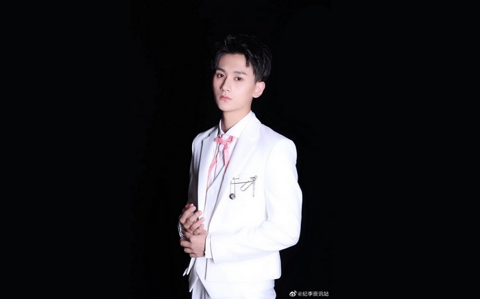 Ji Li in a white suit