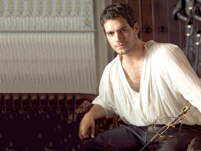 Henry Cavill in historical costume with sword