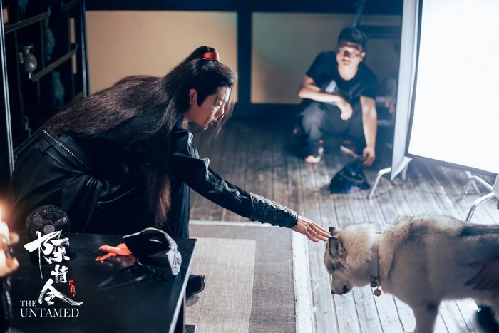 Wei Wuxian from The Untamed petting a dog