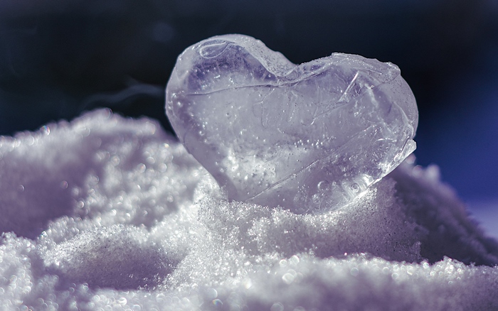 A frozen heart made of ice on snow