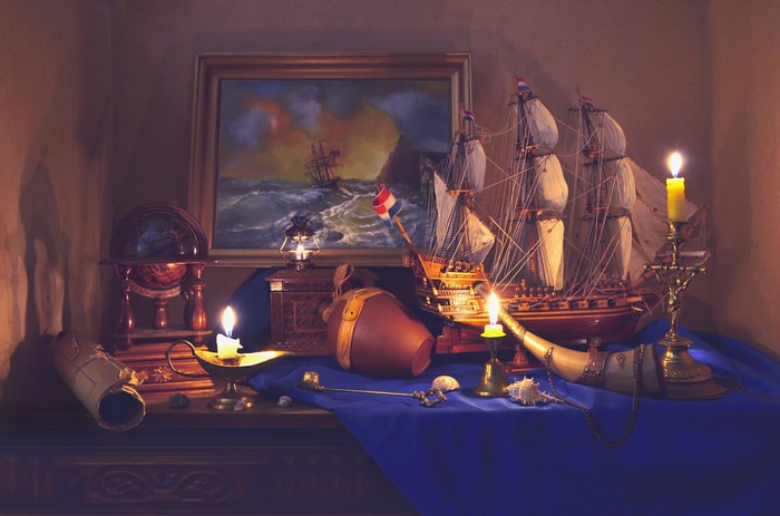 Still life with ship model, globe, and candles