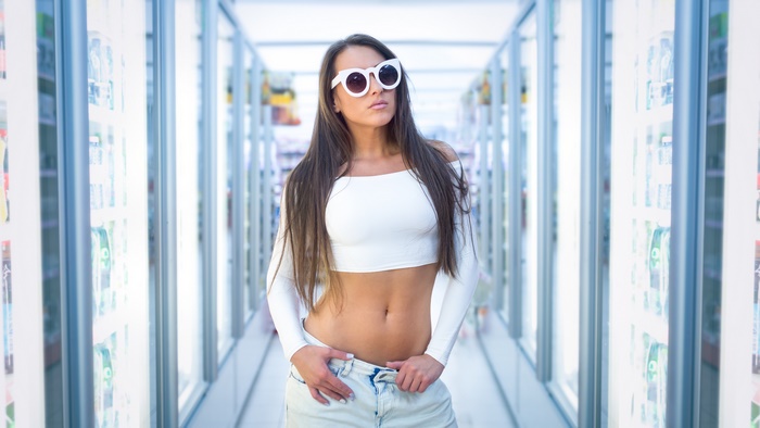 Woman with long hair and sunglasses in a store