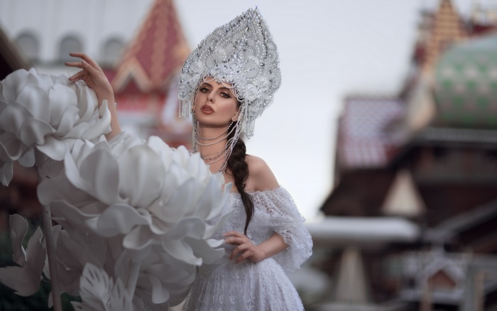 Woman in white dress and headdress with braid