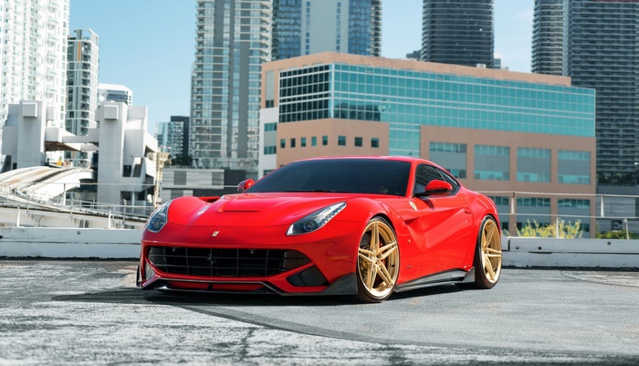 Red Ferrari F12berlinetta with gold wheels