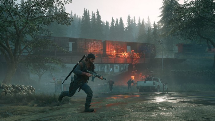 Deacon St. John running with a rifle near burning train cars