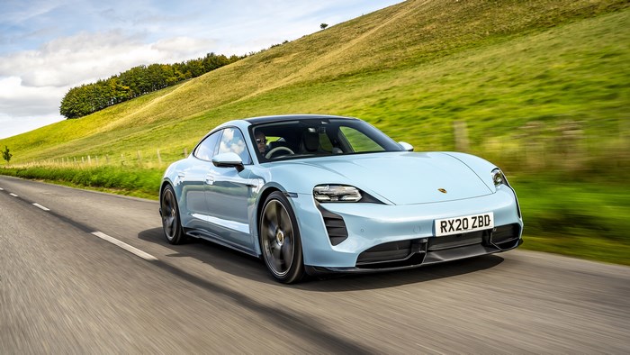 Blue Porsche Taycan 4S driving on a road