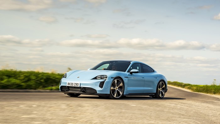 Blue Porsche Taycan 4S driving on a road