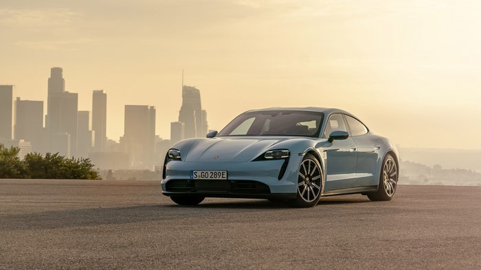 Blue Porsche Taycan 4S in front of Los Angeles skyline