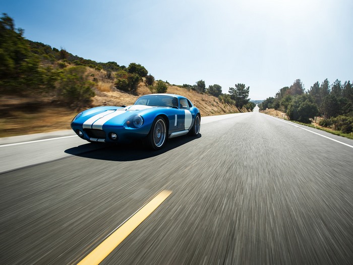 Blue Renovo Coupe driving on a sunny road