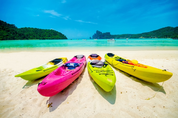 Multicolored kayaks on a tropical beach