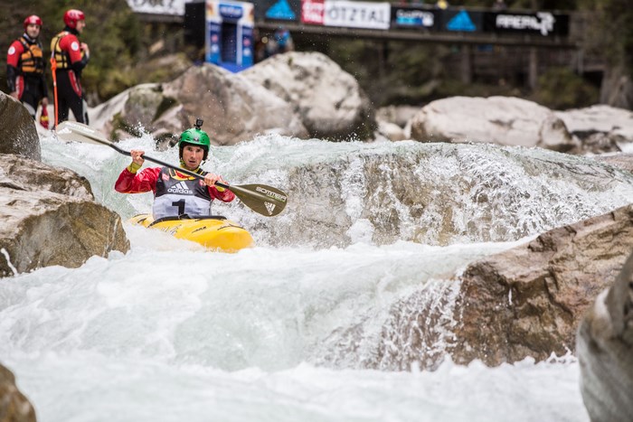 Man kayaking down a rapid river