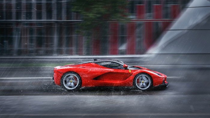 Red Ferrari LaFerrari driving in rain