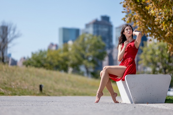 Woman in Red Dress Sitting Outdoors